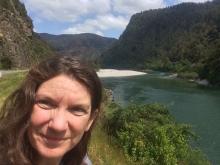 Amy Osborne in front of a river in the middle of the South Island, New Zealand.