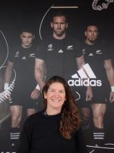 Amy Osborne in front of All Blacks sign