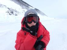 Amy Osborne eating a small sliver of sea ice.