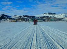 Pisten Bully driving on the sea ice in front of McMurdo Station, Antarctica