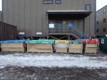 Bins labeled Landfill, Skua, recycling, food waste, and cardboard.