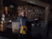 Amy Osborne standing in front of the kitchen in the Terra Nova Hut.