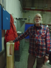 Man standing with filter tube used in desalination facility.