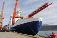 Cranes help to load a large icebreaker