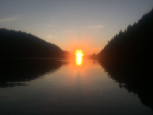 Sunset over water, with two islands in the mid-ground