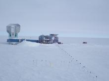 The South Pole Telescope on the left