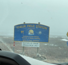 A blue sign with yellow text says "Toolik Field Station". 