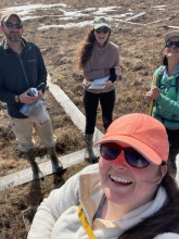 Liza, Jeremy, Sarah, and Ruby stand on boardwalk around a control plot. 