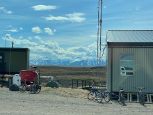 A mountain range peaks out between two buildings. 