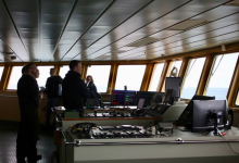 Captain, crew, and researchers gather on the bridge of the Palmer