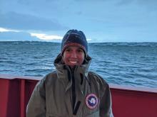 PolarTREC educator Sarah Slack stands in front of the face of Pine Island Glacier