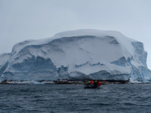 Researchers approach Sif Island in a Zodiac