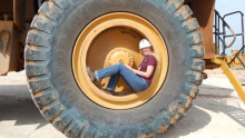 Andrea siting on the rim of a tire.