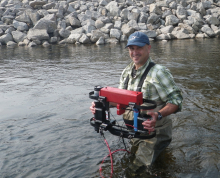 Bruce Taterka sampling the Kuparuk River