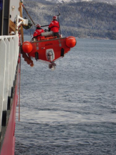 The returning dock hands get hoisted onto the ship!