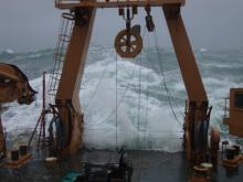 Large wave crashes over the fantail