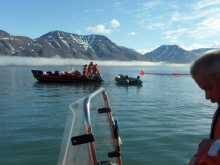 The zodiac is attached to the Cargo boat