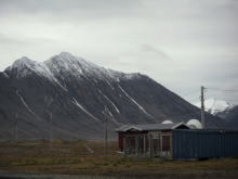 Snow falling on the peaks.