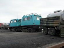 the snow track vehicles roll out to add fuel to the boats.