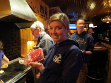 Holding up my raw meat I am about to cook at Trappers 