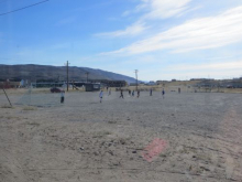 Kids playing soccer.  You don't need grass