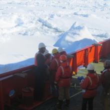 Scientists and techs on deck preparing a jumbo piston core