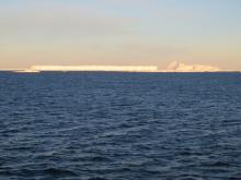 2 icebergs next to each other. Can you see the difference in their shapes?