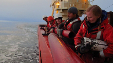 A group of us assembles a jumbo piston core on the starboard side.