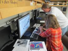 Mikhaila and Stephan reviewing the latest satellite images of ice conditions. 