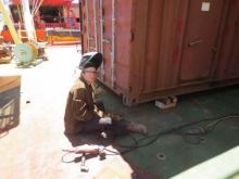 Rosie the riveter! Hannah welding a storage carton.