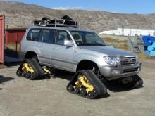 All-terrain vehicle with tracks.