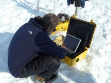 Dr. Konrad Steffen downloading data from the data logger.