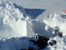 Two snow pits, side by side to create a back-lit snow profile.