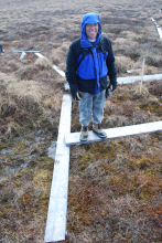 Rosvel is standing in a tundra areas  that is sinking.  Notice the water beginni