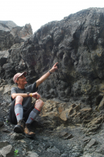 Mr. Wood points at one of the dinosaur footprints