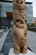 Maori sculpture and modern building 