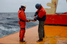 Barry and Jim attaching an instrument on the line.