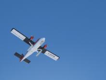 A "Twin Otter" plane takes off.