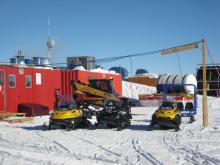 Snow mobiles plugged in at the IceCube Hitchin' Post.