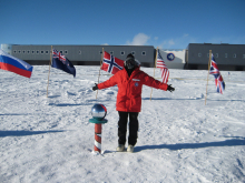 Standing at the ceremonial south pole behind the station.