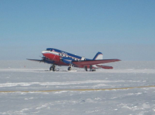 A tourist plane parked off the runway