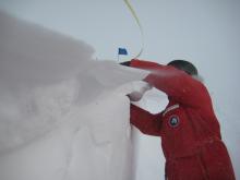 Bakhtiyar explores wind drifts in the trench.