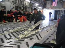 Inside the crew does a quick-change of the plane's equipment.