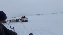 Sofus Alataq drives a sled to share his experience with OIB