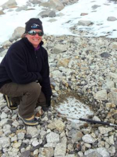 Lesley next to 15,000 year old glacial ice in Antarctica.