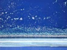 Hull and Water:  Looking down the side of the Sikuliaq into the water.