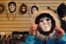 Lisa Seff wearing a mask by artist Dora Mae Buchea "Umara Nupuwhotuk" at the Museum of the North at the University of Alaska Faribanks.