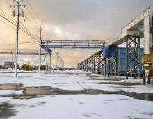 NARL with snow:NARL (Naval Arctic Research Lab) where we live/work partially covered in snow. The structure up in the air is the utilador, an insulated box through which pipes for water and sewer run. 