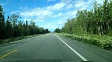 The view from the car on the road from Anchorage to Kasilof.  Here we had left the mountains around Turnagain Arm and were driving west towards Soldotna.