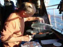  Steve cooking dinner on the Annika Marie.  note the beautiful weather outside.